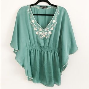 teal top with floral details